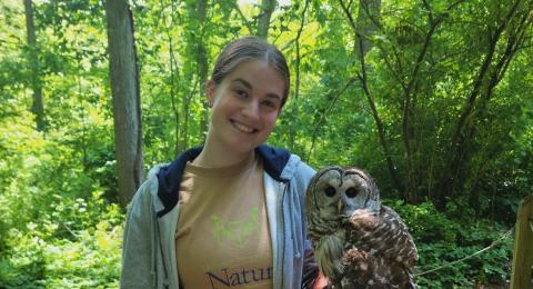 UNH student Madi Wing with an owl