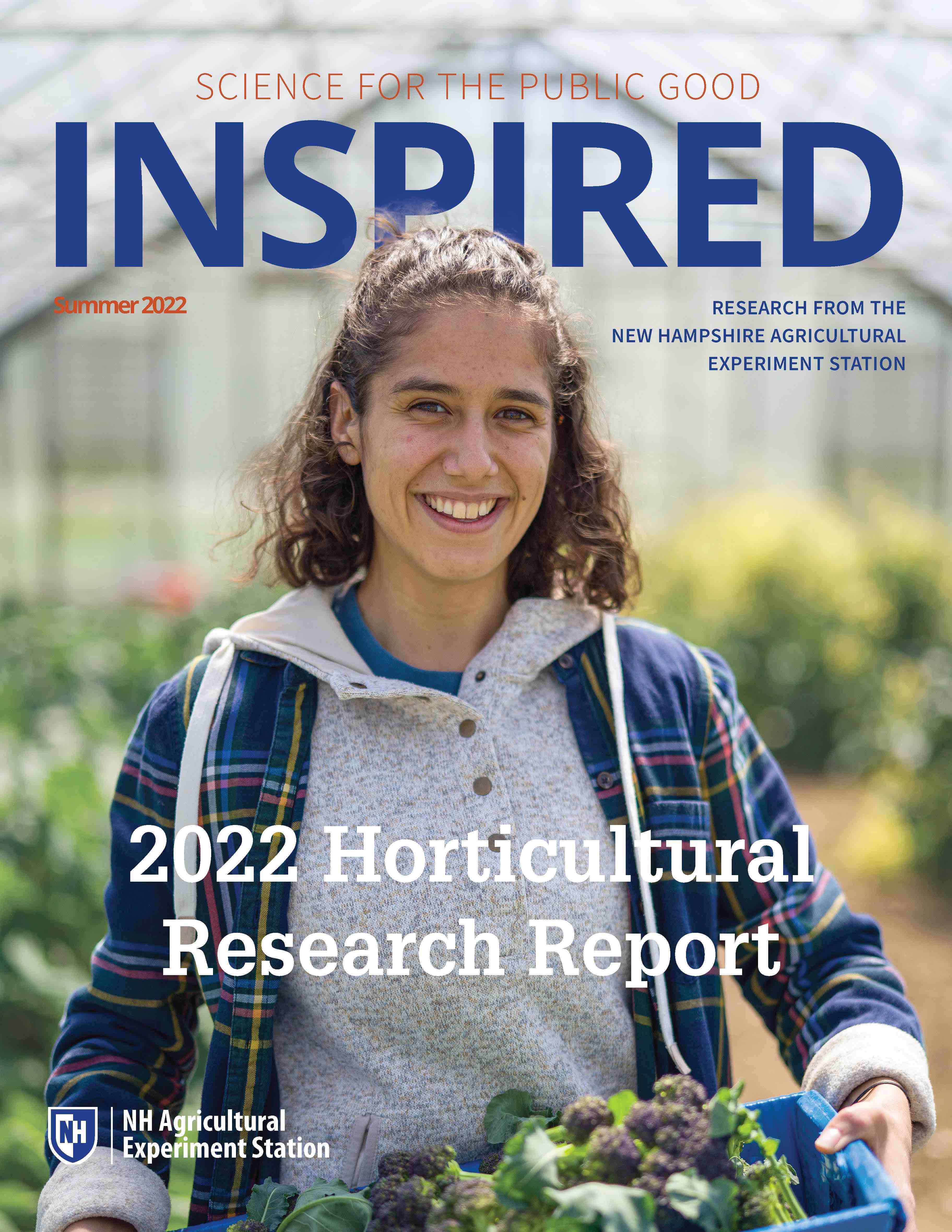 A photo of INSPIRED: Horticulture Summer 2022 cover showing a COLSA student holding up produce grown at Woodman Horticultural Research Farm