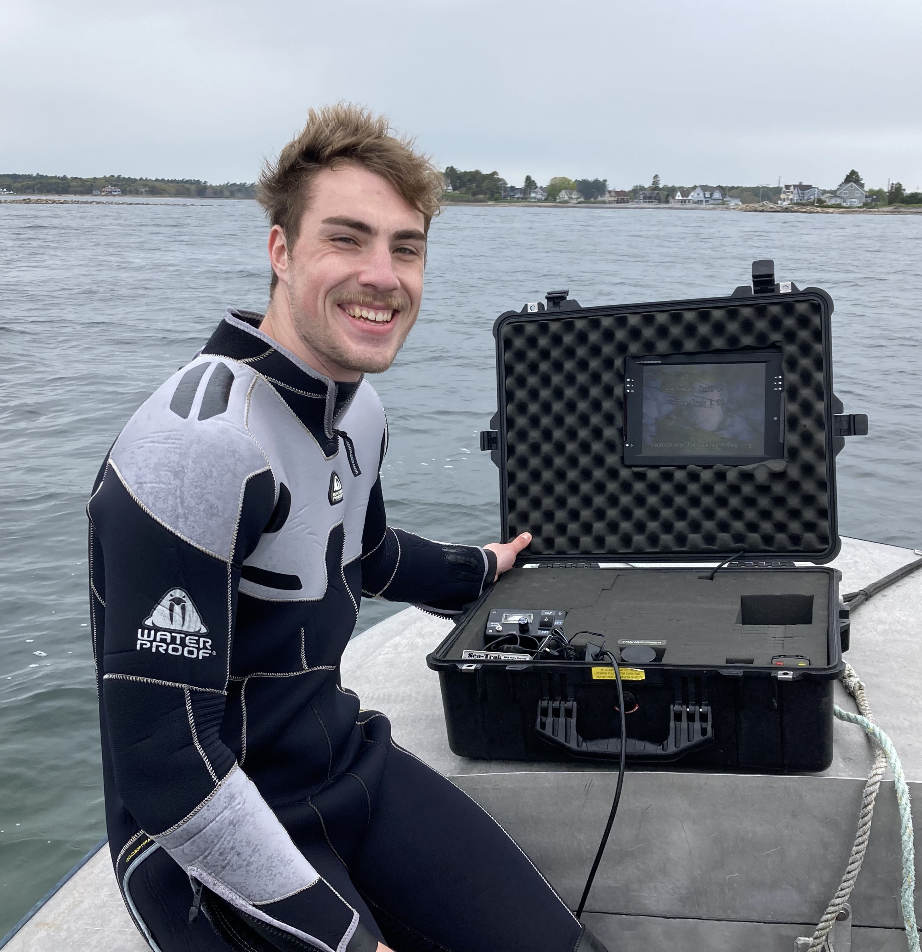 A photo of Biological Sciences graduate student Grant Milne in diving gear out on NH's Great Bay Estuary