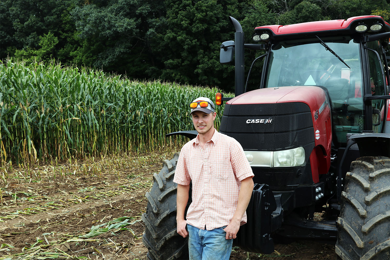 A photo of UNH Farm Services manager Peter Davis leaning on a tractor.