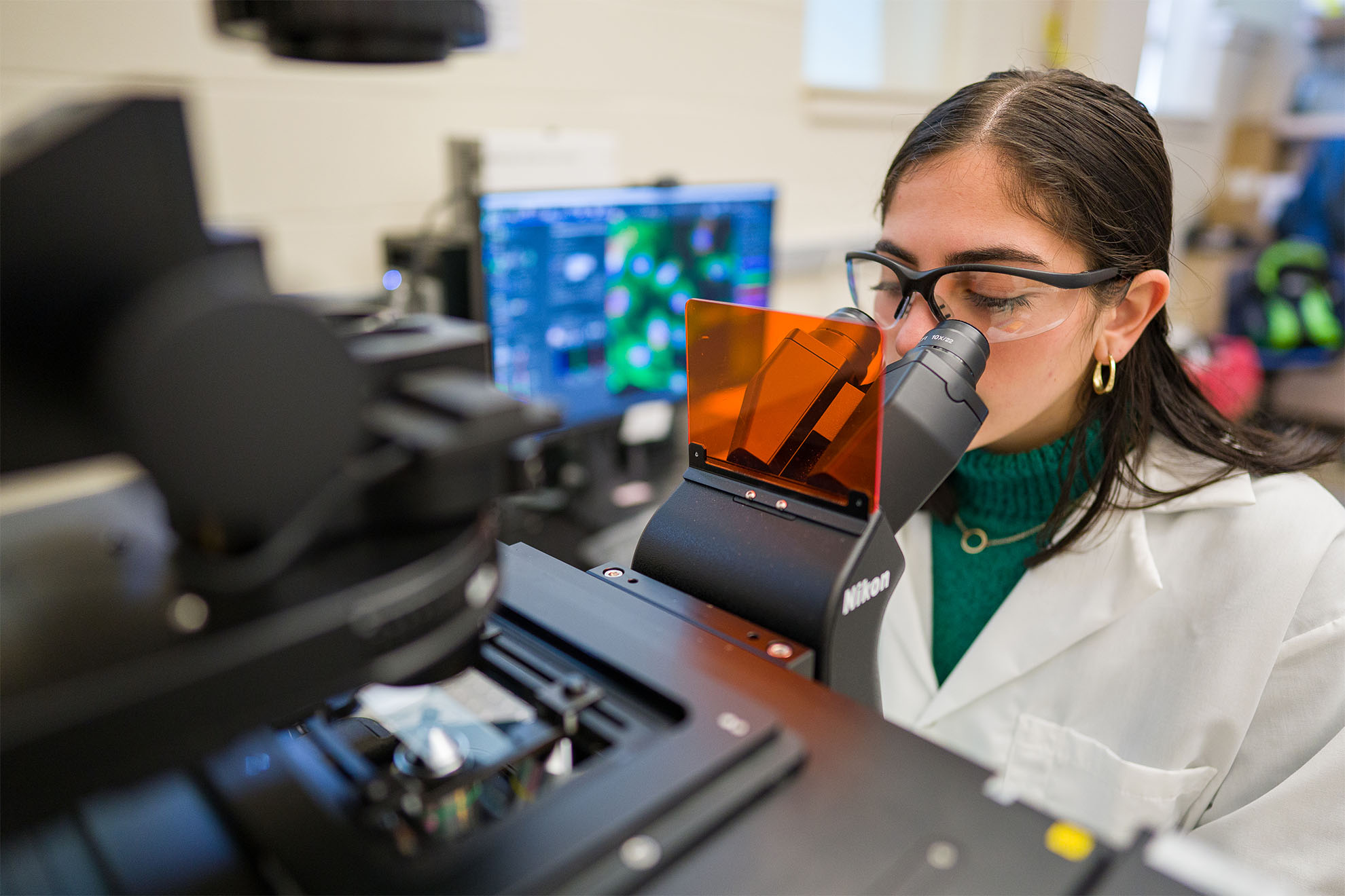 Graduate student Gabriella Palermo looks into a confocal microscope at the UNH University Instrumentation Center.