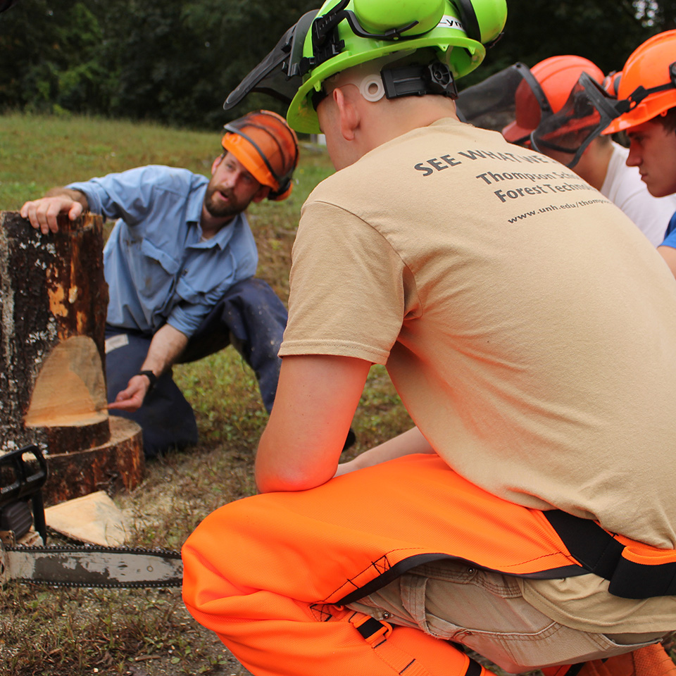 Mike Simmons teaching about cutting logs