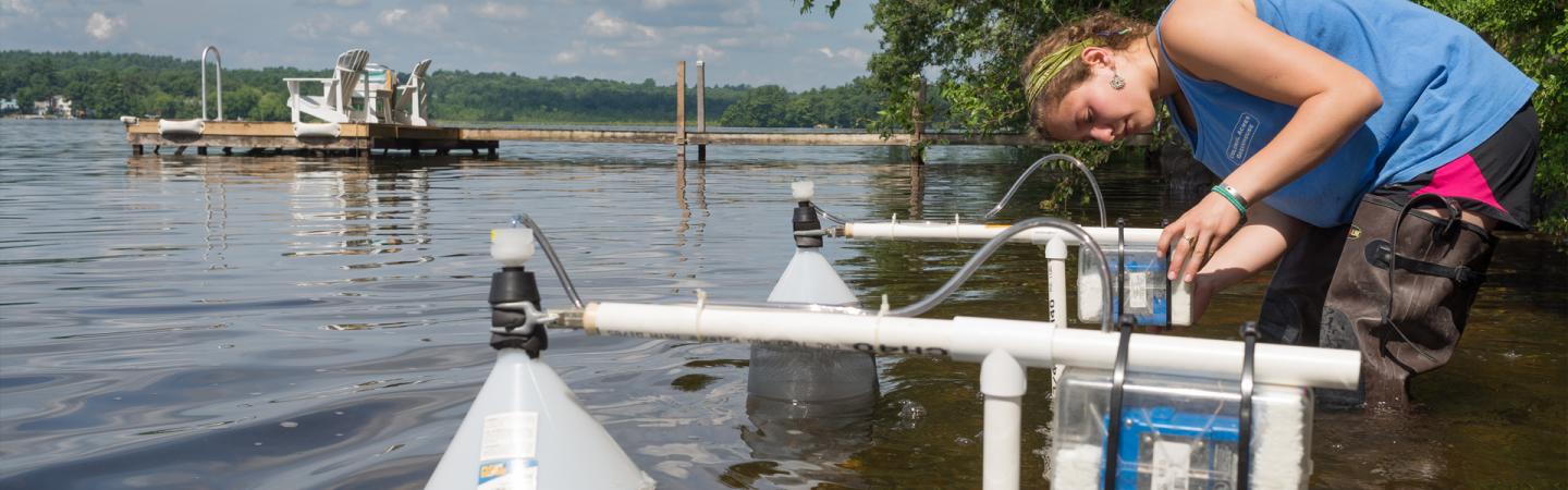 Student calibrating water testing equipment
