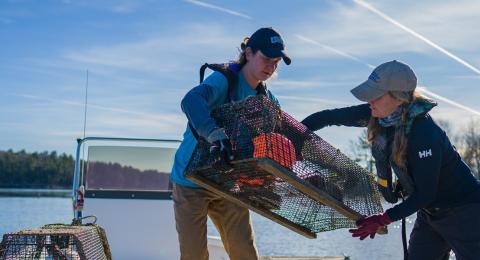 students in boat with traps