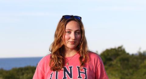 UNH graduate student Rachel Lewis outside by the ocean