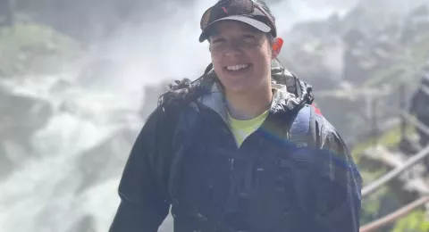 UNH graduate student Danielle Fradet in front of a waterfall