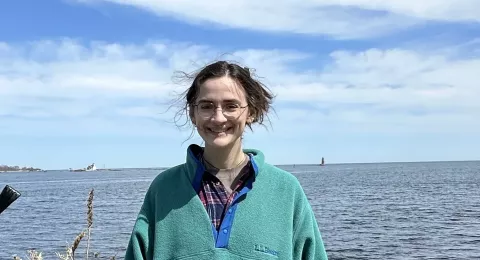 UNH grad student Marley Gonsalves poses by the ocean