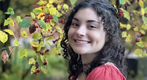 UNH undergrad Nia Lessard poses under a tree