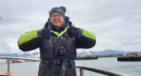 UNH grad student Sierra Rose Walsh gives two thumbs up on UNH research vessel