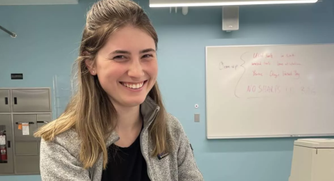 UNH student Lilah Read holding a brain in a UNH lab