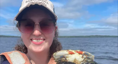 Caylin smiling holding a crab