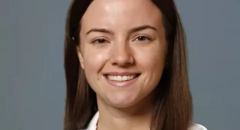 UNH alumna and medical school student Samantha Ansart in her white coat 