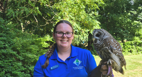 Kaylee Finch smiling holding an owl