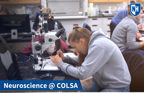 A thumbnail of neuroscience students looking in microscopes in a lab