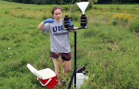 A CEPS student gathers rainwater collected for a PFAS measurement study.