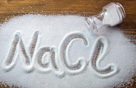 A jar of salt with the text NaCL spelled out in spilled salt