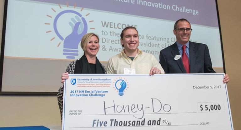 Honey-Do's Andrew Demeo and Jessica Waters pose for a photo with an award check.