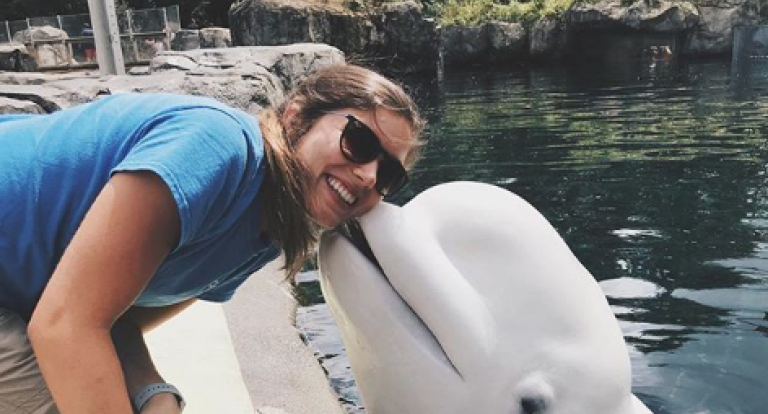 Lindsay Bosworth receives a kiss during her summer internship at Mystic Aquarium