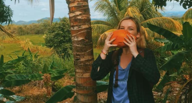 Taylor Zupo drinks fresh coconut water in Peru.