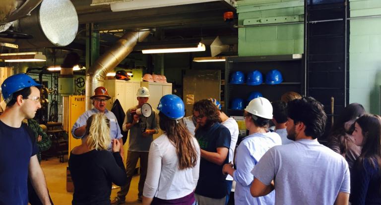 A group of students wearing hard hats on a tour of the UNH Cogen Plant.