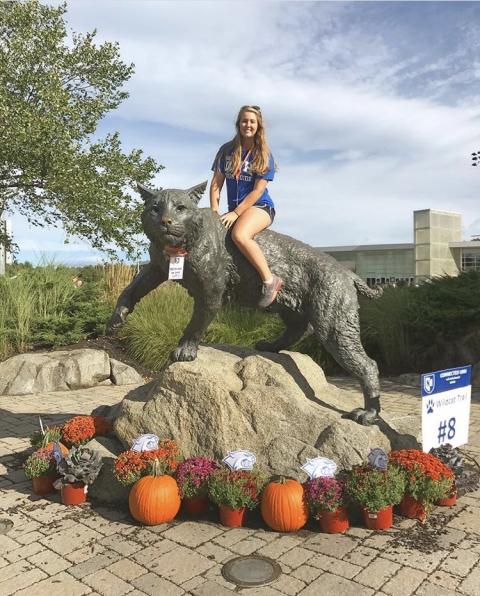 Hannah Ziegel '20 poses with UNH wildcat statue