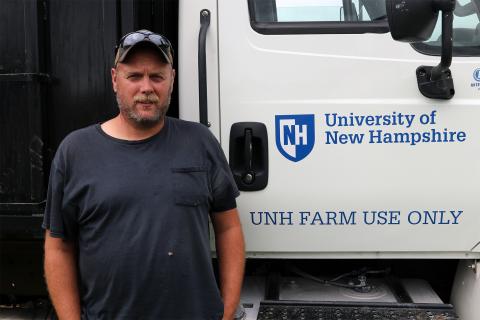 A photo of UNH lead farmer Terry Bickford with the UNH Farm Use Only notice in the background.