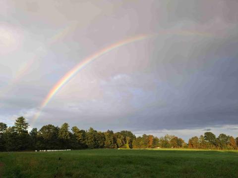 A rainbow shows of the Organic Dairy Farm at UNH.