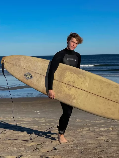 UNH student Noah Hopkins on the beach