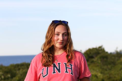 UNH graduate student Rachel Lewis outside by the ocean