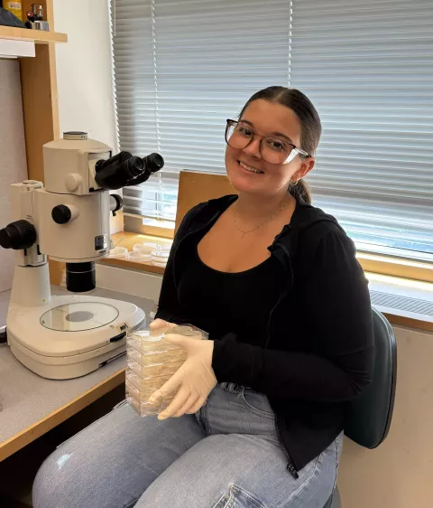 UNH genetics student Riley Wilson in the lab