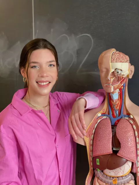 UNH graduate student Camryn Berry poses with an anatomical human model