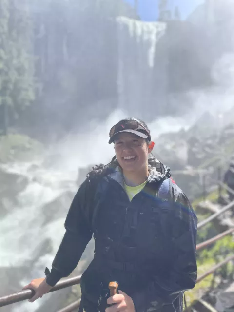 UNH graduate student Danielle Fradet in front of a waterfall