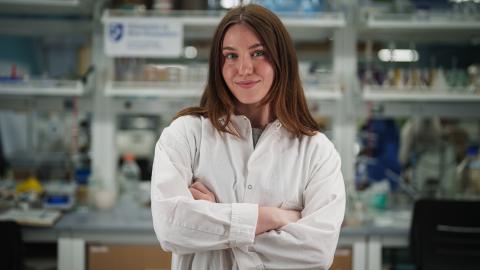 undergraduate student gabrielle jarrett in a lab while wearing a lab coat