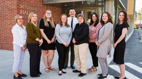 An image of COLSA's student success team standing outside Rudman Hall