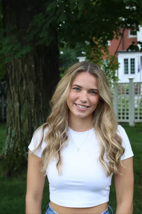 UNH undergraduate Corinne Fernald outside next to a tree
