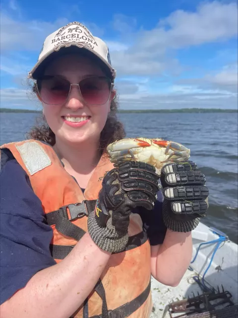 Caylin smiling holding a crab