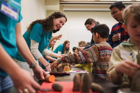 UNH student interacting with a child during a 4-H event 