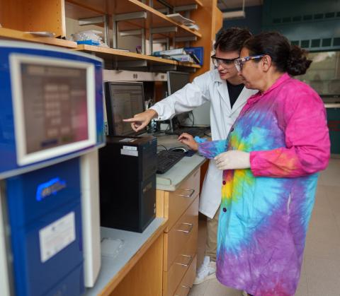 Associate Professor Sherine Elsawa works with a student in her lab