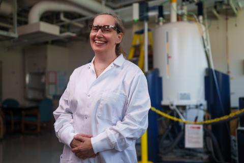Associate Professor Krisztina Varga poses in goggles and lab coat in the UNH Instrumentation Center