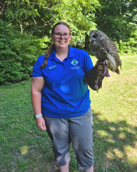 Kaylee Finch smiling holding an owl