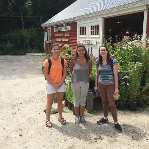 Students standing in front of a barn