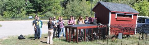 Student at new campus chicken coop