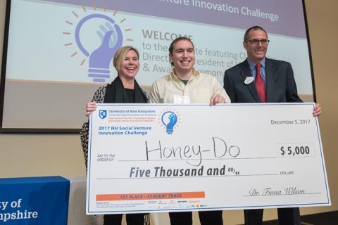 Honey-Do's Andrew Demeo and Jessica Waters pose for a photo with an award check.
