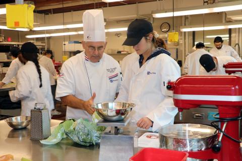 Professor Charlie Caramihalis instructs a student enrolled in the culinary nutrition and food studies minor