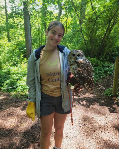 UNH student Madi Wing with an owl