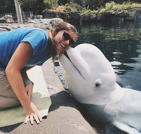 Lindsay Bosworth receives a kiss during her summer internship at Mystic Aquarium